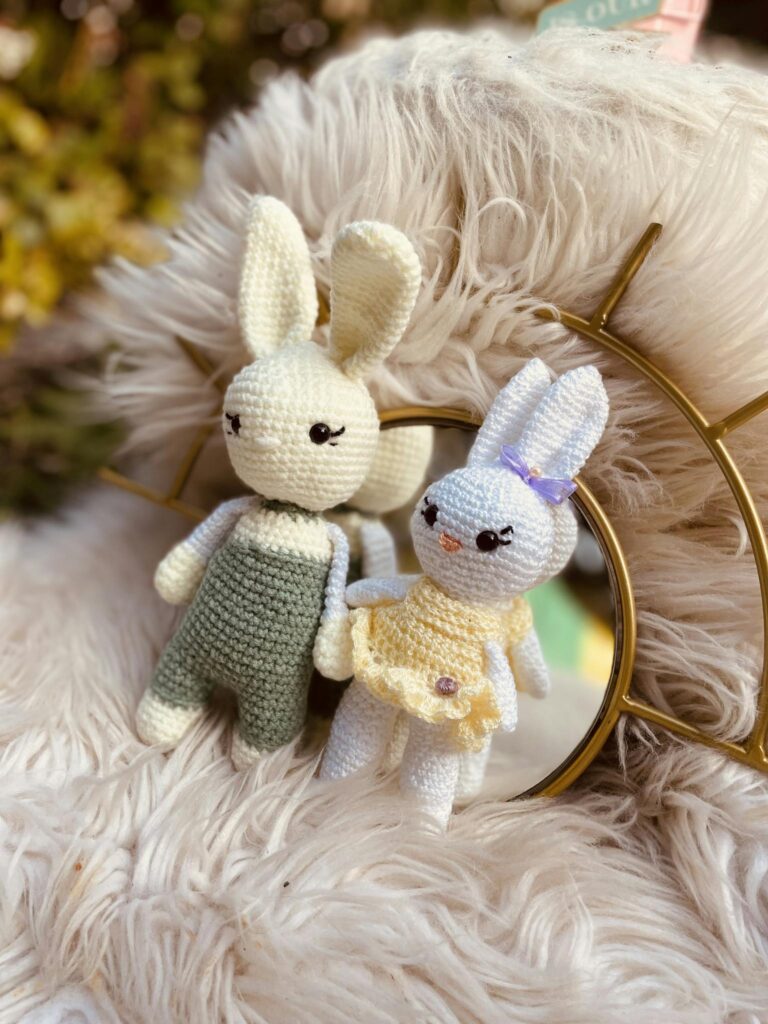 Adorable handmade crochet rabbit dolls in pastel outfits, perfect for gifts or decor.